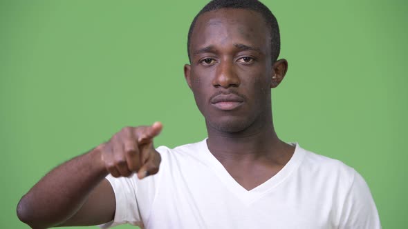 Young African Man Pointing at Camera