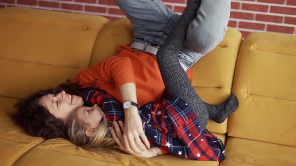 Mother and Small Child Preschool Girl Enjoying Bonding Jumping on Couch