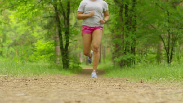 African Female Jogger Tying Undone Laces on Trainer