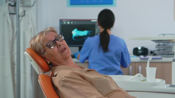 Senior Woman Looking on Camera Waiting on Dental Clinic