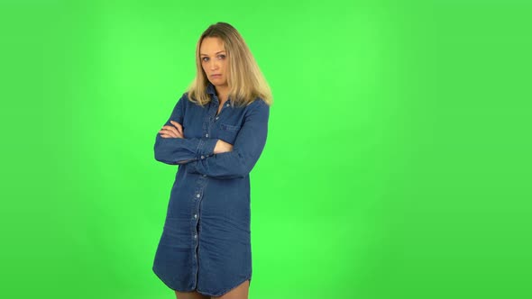 Fair Woman Is Standing Offended and Then Smiling. Green Screen