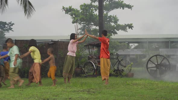 Thai children folk, boys and girls in family, playing local traditional game in Thai culture