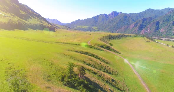 Aerial Rural Mountain Road and Meadow at Sunny Summer Morning