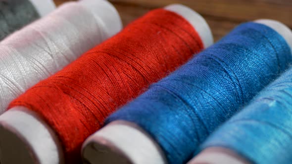 Spools of Colored Thread Close-up. Textile Industry. Sew with a Needle and Thread. Embroider on