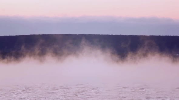 Steam Floats Over the Water at Dusk After Sunset