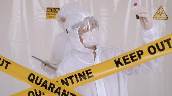 A Doctor in a Protective Suit with a Blood Test for Coronavirus in the Hospital.