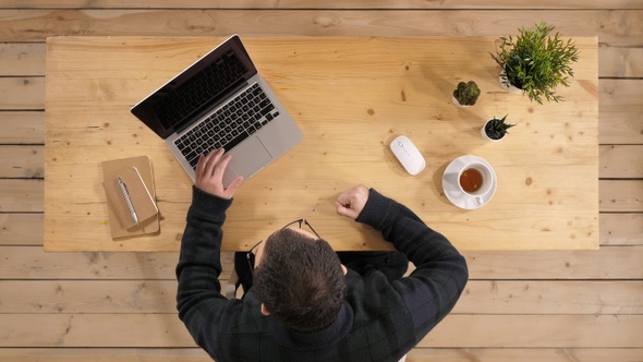 Angry businessman infront of laptop