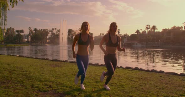 Athletic Twins Running In The Park Slow-Motion