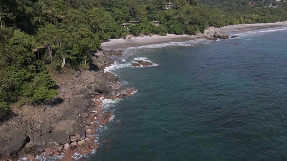 slowly turning aerial view of the rocky coastline at the western shores of puerto rico where the pac