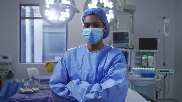 Portrait of asian female surgeon wearing face mask standing in hospital operating theatre