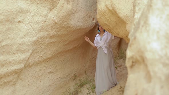 Asian Girl In Authentic Dress Between Orange Valley