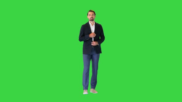 Young Businessman in Suit Talking To Camera on a Green Screen Chroma Key