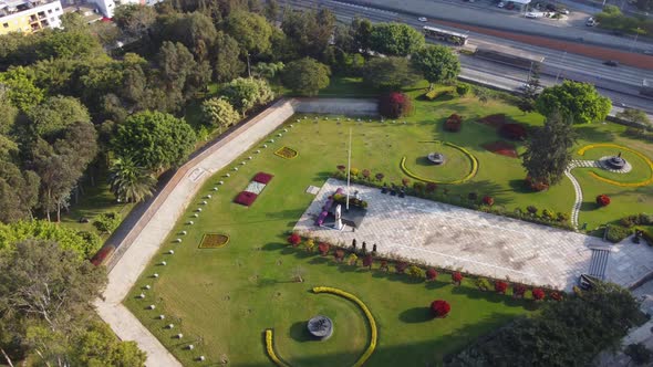 Drone video of "Parque Reducto" a park in Miraflores district of Lima, Peru. Green grass and trees c