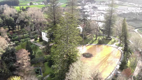 Charming house surrounded by trees and a pond. Light rays and shadows. Sao Miguel Island, Azores