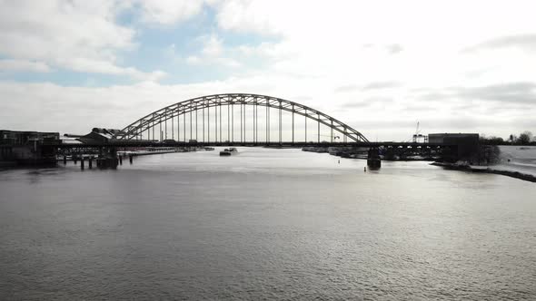 Aerial view of road bridge over a river in industrial urban area