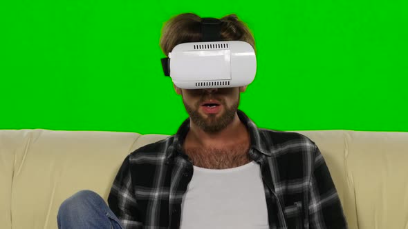 Man Fascinated By the Movie in VR the Mask. Green Screen