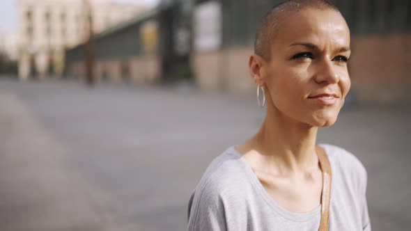 Smiling bald woman wearing t-shirt walking