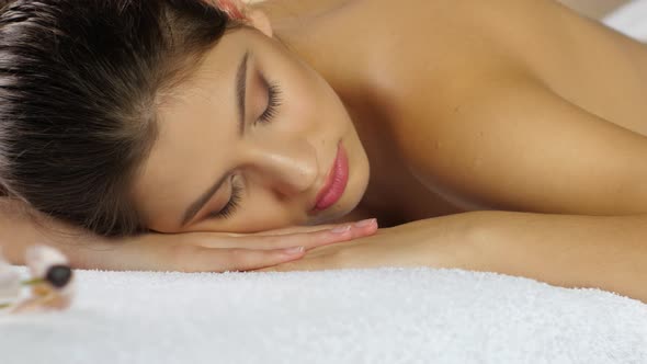 Rest After Spa Treatments. Girl Sleeps on the White Towels