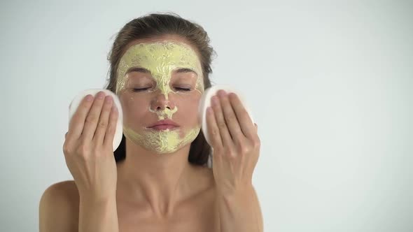 The Girl Removes the Mask From Her Face with a Sponge