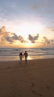 Couple Men and Woman Walking on the Beach During Sunset in Khao Lak Thailand