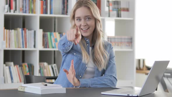 Young Woman Pointing with Finger at Camera