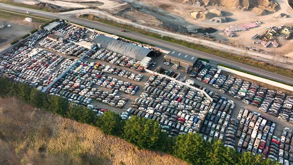 Aerial View of Big Parking Lot of Junkyard with Rows of Discarded Broken Cars