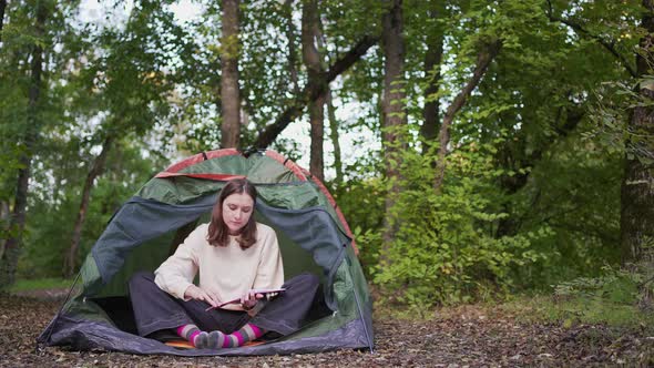 Reading Literature in a Tent at a Campsite