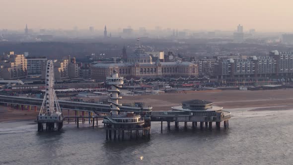 Aerial parallax of the ferris wheel and viewpoint tower on the pier of Scheveningen in Den Haag at s