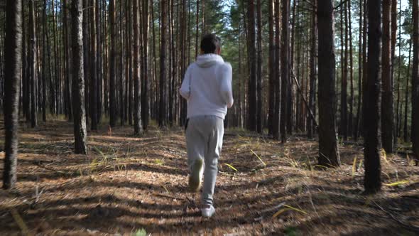 Young Fit Boy Jogging on Woods Road