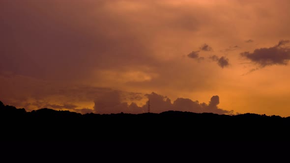 Time lapse beautiful nature of blue sky and clouds at sunset with silhouettes of mountains.