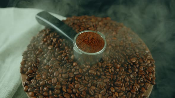 Ground Coffee in Portafilter on Wooden Board with Coffee Beans and Dissipating Steam