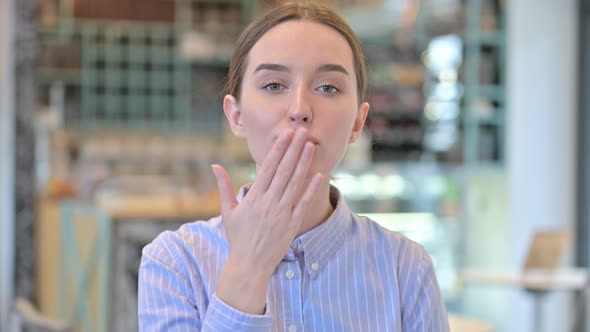 Portrait of Flying Kiss By Attractive Young Businesswoman 