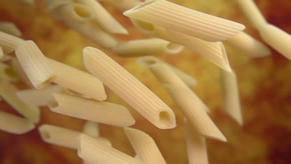 Closeup of the Pasta Penne Falling Diagonally on a Yellow Ochre Background