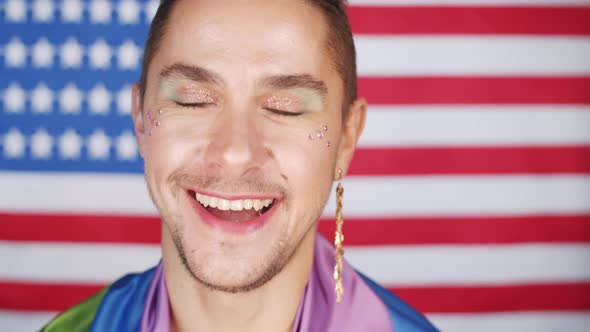 Fashionable Gay Man Posing for Camera against American Flag