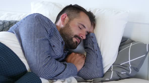 Young Beard Man Sleeping in Bed