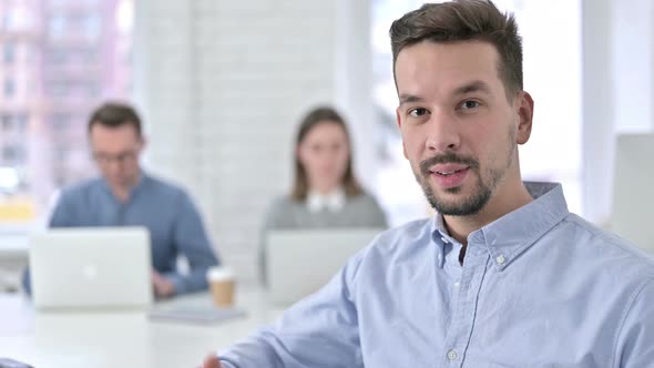 Ambitious Creative Team Doing Thumbs Up in Modern Office