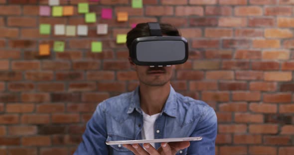 Creative businessman using virtual reality headset in modern office