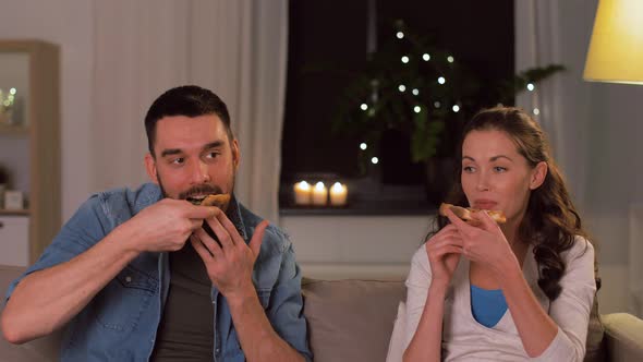 Happy Couple Eating Takeaway Pizza at Home