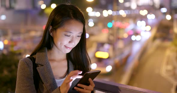 Woman read on smart phone in city