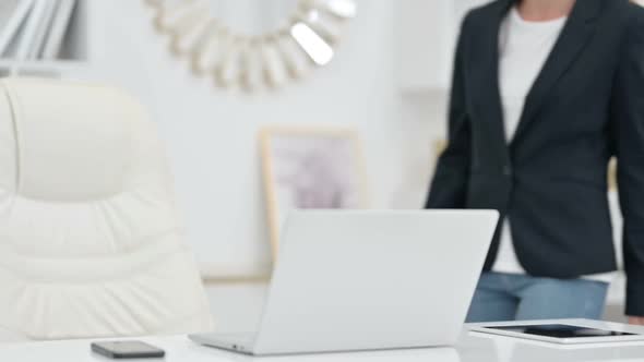 Young Businesswoman Coming Back and Opening Laptop