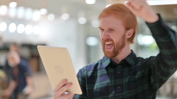 Portrait of Beard Redhead Man Celebrating Success on Tablet, Winning 