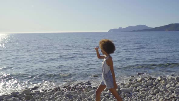 Slow motion shot of young woman enjoying view at the beach