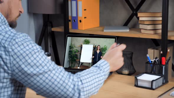 Man Student Study at Home Office Online Video Call Laptop Writes in Notebook