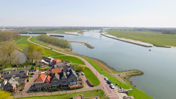 Aerial view approaching boat on river in Dutch countryside