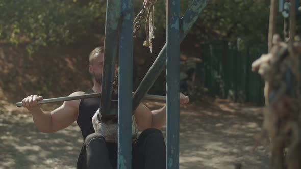 Muscular Man Working Out Lat Pulldown Machine