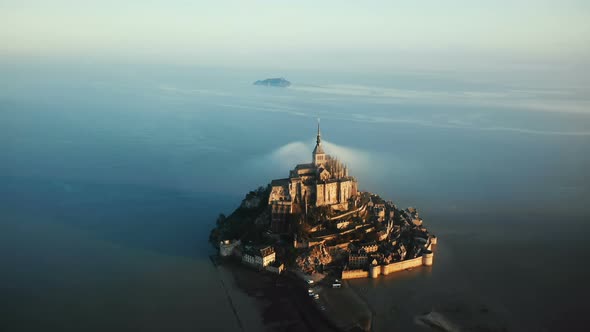 Cinematic Aerial Shot of Ethereal Sunrise Mont Saint Michel Island Castle Surrounded By High Tide