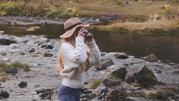 Woman Photographing In River With Old Camera