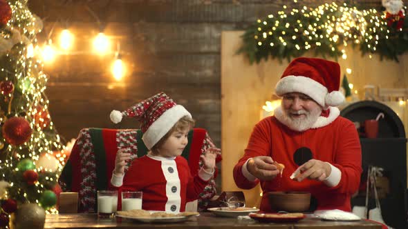 Santa Claus with Child Grandson Prepare Christmas or New Year in Santa Hat, Bake Christmas Cookies