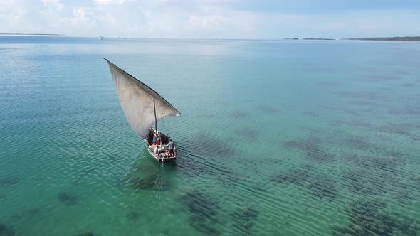 A Boat Floats on the Water of the Ocean Near the Coast of Zanzibar Tanzania