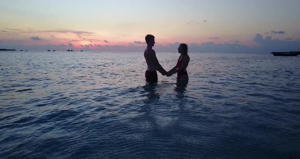 Happy people on romantic honeymoon have fun on beach on summer white sandy 4K background